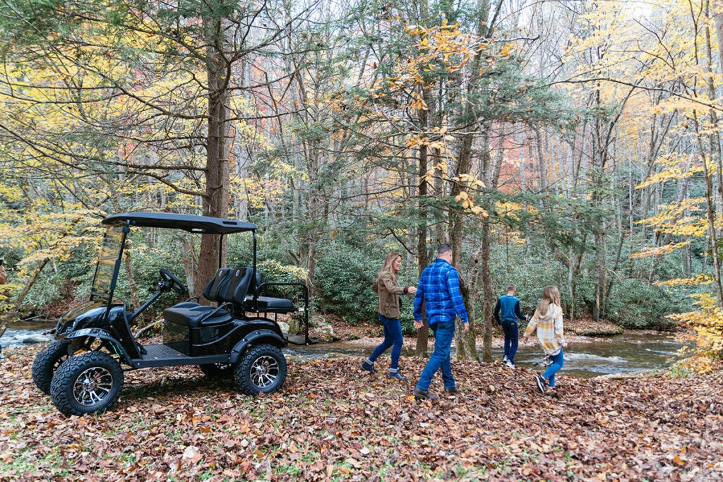 Family taking their golf cart camping and fishing by the river - MD Carts Pro Cart